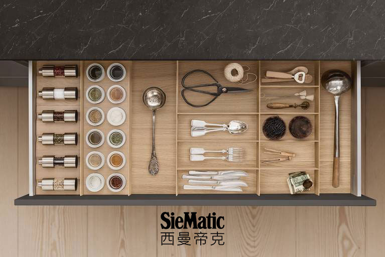 Cutlery, spice mills and porcelain jars in drawer with SieMatic kitchen interior accessories