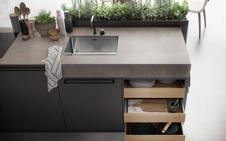 Kitchen island with SieMatic StoneDesign countertop and herb garden from the Urban style collection